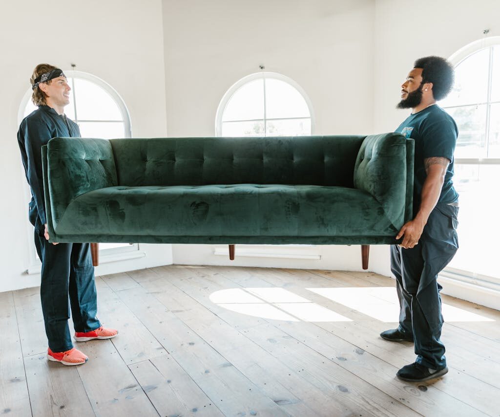 Close-Up Shot of Men Carrying a Couch